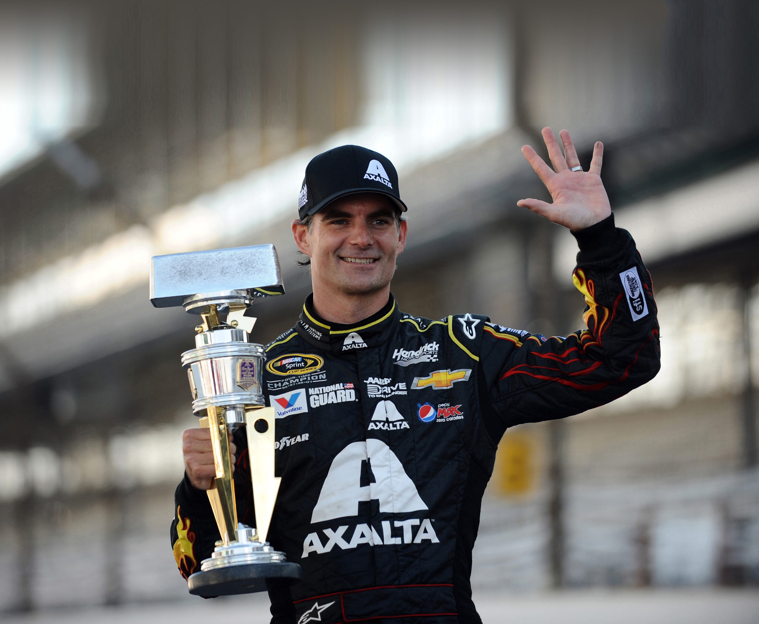 Jeff Gordon, driver of the #24 Axalta Chevrolet, celebrates with the trophy after winning the NASCAR Sprint Cup Series Crown Royal