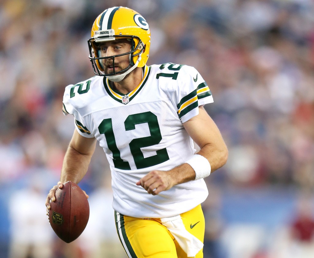 Green Bay Packers quarterback Aaron Rodgers (12) scrambles out of the pocket in action against the New England Patriots at Gillette Stadium in Foxboro, MA August 13, 2015. (AP Photo/Damian Strohmeyer)
