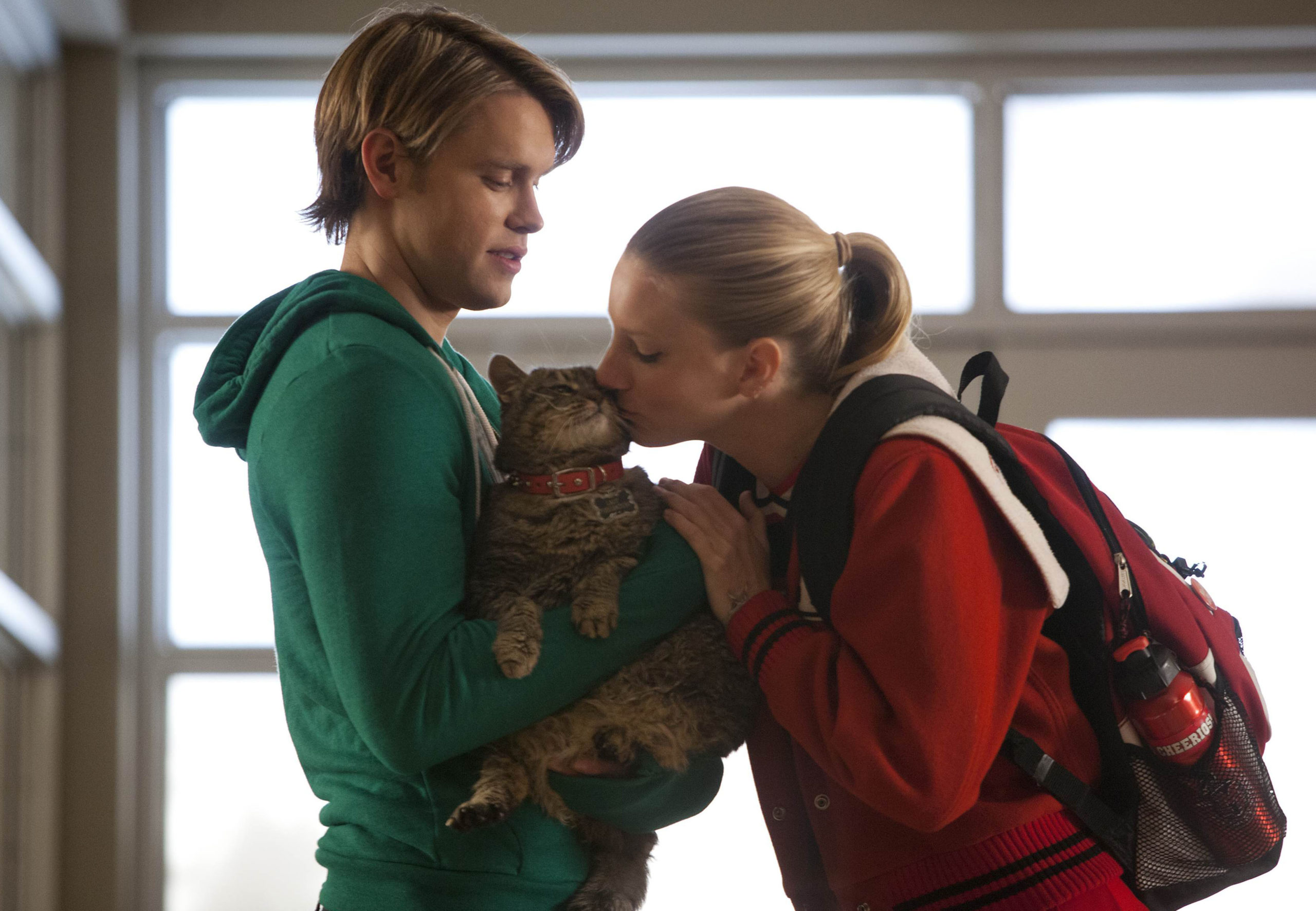 Chord Overstreet as Sam with Heather Morris as Brittany kissing Lord Tubbington on FOX's Glee, Season 4