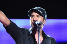 Luke Bryan points at the cheap seats while performing onstage during the 2015 CMT Artists of the Year