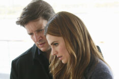 Nathan Fillion and Stana Katic look at a video recorder in Castle