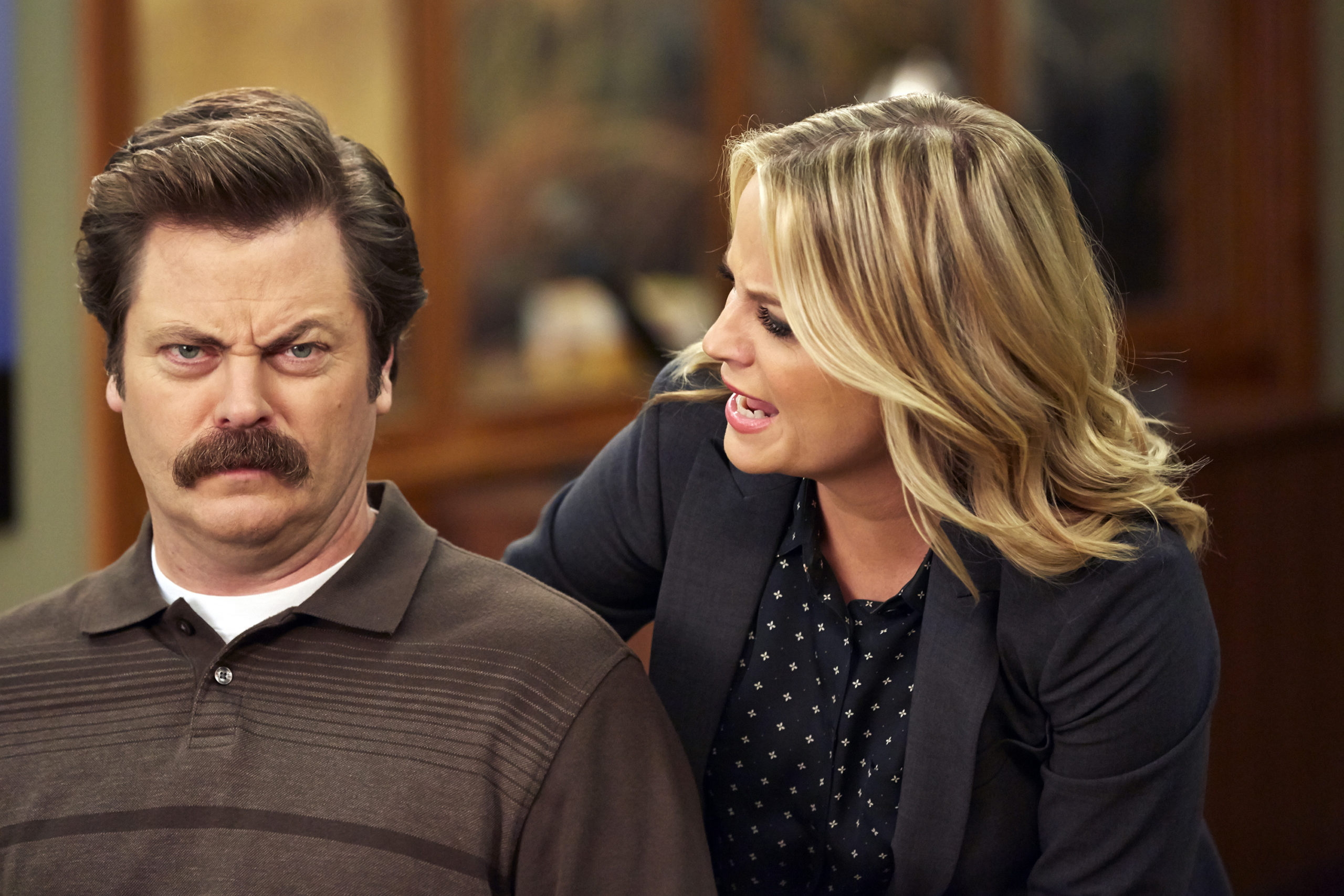 Nick Offerman as Ron Swanson and Amy Poehler as Leslie Knope in Parks and Recreation