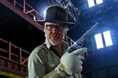 Mythbuster Adam Savage wearing a protective glove for the gun whip test