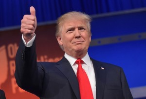 Real estate tycoon Donald Trump flashes the thumbs-up as he arrives on stage for the start of the prime time Republican presidential debate on August 6, 2015 at the Quicken Loans Arena in Cleveland, Ohio.