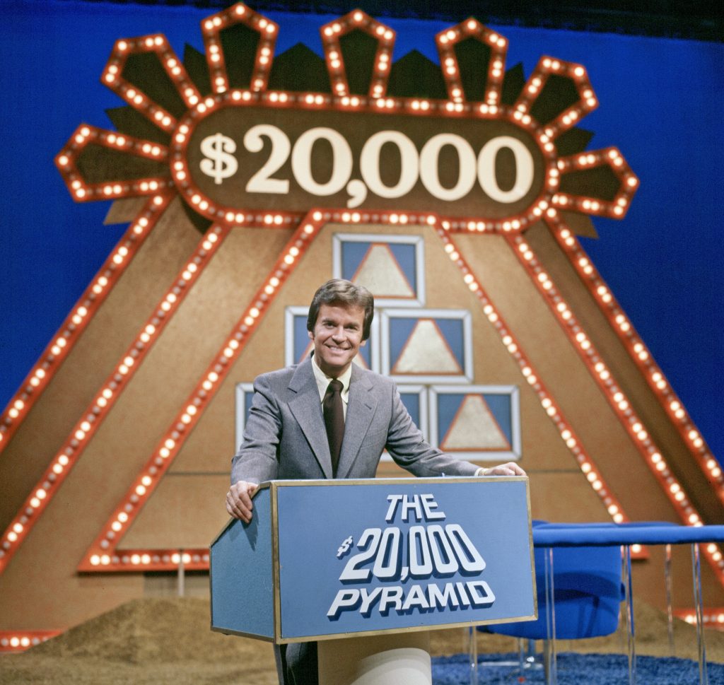 UNITED STATES - JANUARY 20: $20,000 PYRAMID - 9/19/75, On "$20,000 Pyramid", a contestant and a celebrity guest selected one category of six on a pyramid-shaped board, and playing against the clock, had 30 seconds to guess seven words, phrases or names using clues given by his/her celebrity partner., Pictured: host Dick Clark, (Photo by Ann Limongello/ABC via Getty Images)