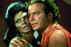 James T. Kirk and Nyota Uhura embrace in Star Trek
