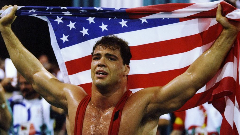 Kurt Angle of the United States holds the American flag at the freestyle wrestling competition during the Summer Olympics
