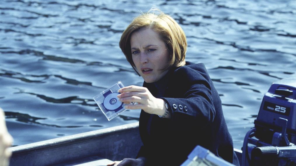 The X-Files - Gillian Anderson as Dana Scully holding up a disc drive
