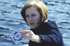 The X-Files - Gillian Anderson as Dana Scully holding up a disc drive