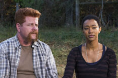 Michael Cudlitz as Sgt. Abraham Ford and Sonequa Martin-Green as Sasha Williams sitting on a log - The Walking Dead - Season 7 finale