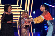 Taraji P. Henson accepts the Best Fight Against The System award for 'Hidden Figures' from U.S. Representative Maxine Waters and actor Tracee Ellis Ross onstage during the 2017 MTV Movie And TV Awards