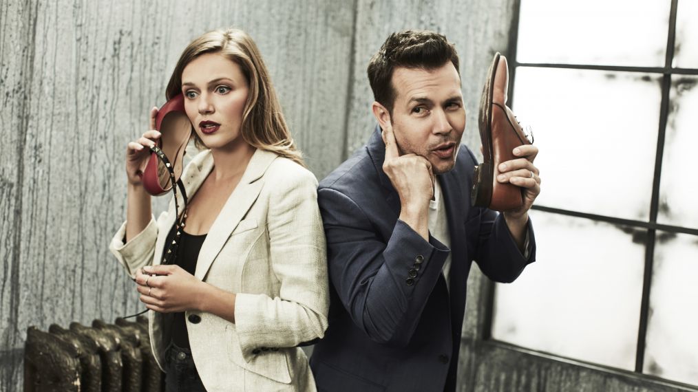 Tracy Spiridakos and Jon Seda talking into their shoe phones in the NBCUniversal Portrait Studio, August 2017