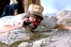 Director Steven Spielberg on a miniature set for Raiders of the Lost Ark