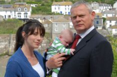 Caroline Catz as Louisa Glasson and Martin Clunes as Dr. Martin Ellingham holding a baby in Doc Martin