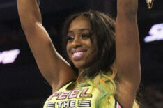 Naomi holding up WWE Title Belt