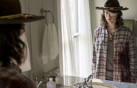 Chandler Riggs as Carl Grimes looking the mirror on 'The Walking Dead'