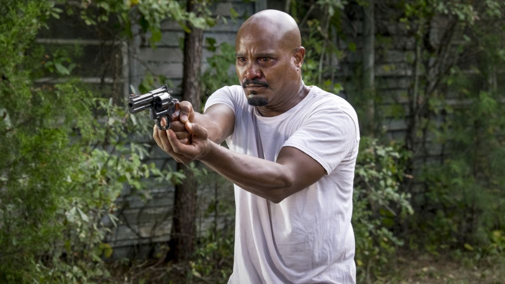 Seth Gilliam as Father Gabriel Stokes holding a gun in The Walking Dead - Season 8, Episode 11