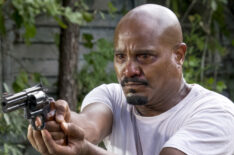 Seth Gilliam as Father Gabriel Stokes holding a gun in The Walking Dead - Season 8, Episode 11