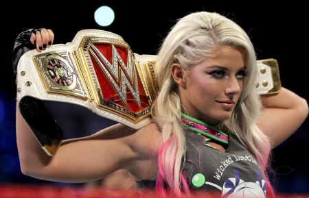 Alexa Bliss holds up her WrestleMania belt