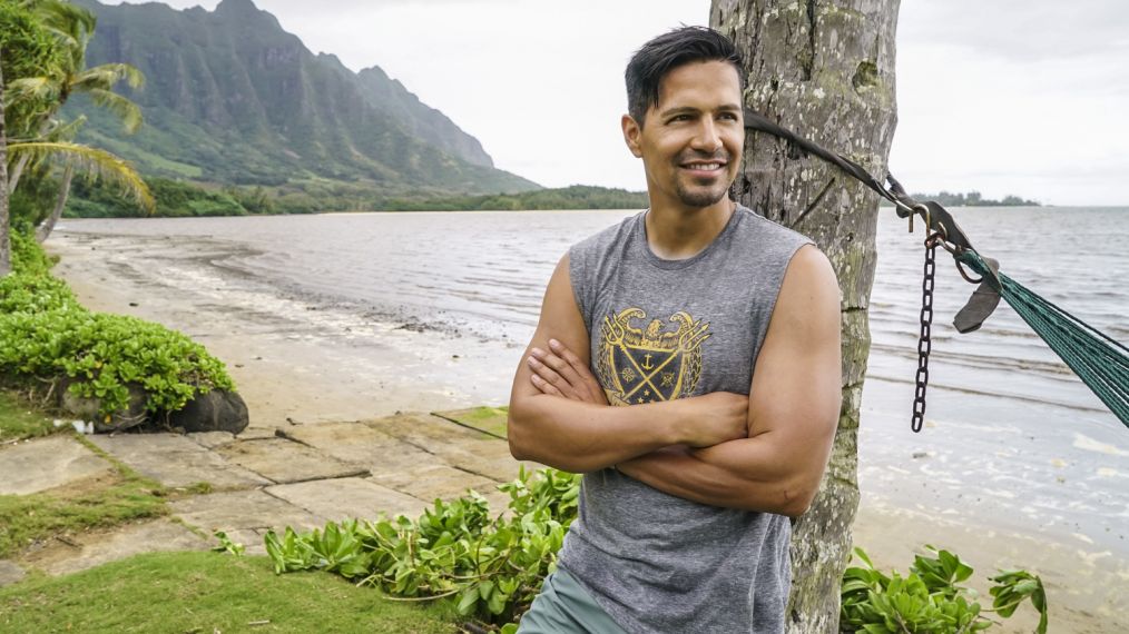 Jay Hernandez as Thomas Magnum leaning against a tree in Magnum P.I.