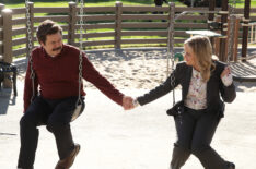 Nick Offerman as Ron Swanson and Amy Poehler as Leslie Knope holding hands on a swing in Parks and Recreation - Season 7