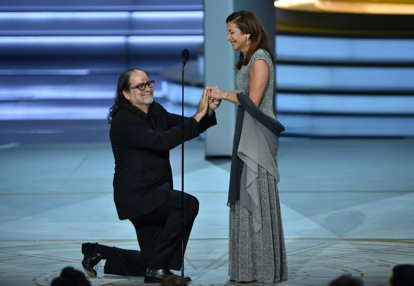 Glenn Weiss (L), winner of the Outstanding Directing for a Variety Special award for 'The Oscars,' proposes marriage to Jan Svendsen onstage during the 70th Emmy Awards at the Microsoft Theatre in Los Angeles, California on September 17, 2018. (Photo by Robyn BECK / AFP) (Photo credit should read ROBYN BECK/AFP/Getty Images)