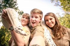 Terri Irwin, Robert Irwin, and Bindi Irwin with a snake