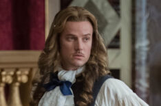 Evan Williams behind the scenes in costume hemming as Chevalier in Versailles