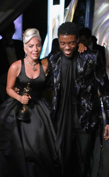 Lady Gaga poses with the Music (Original Song) award for 'Shallow' from 'A Star Is Born' backstage with presenter Chadwick Boseman during the 91st Annual Academy Awards