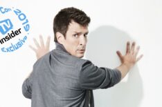 Nathan Fillion with hands against the wall
