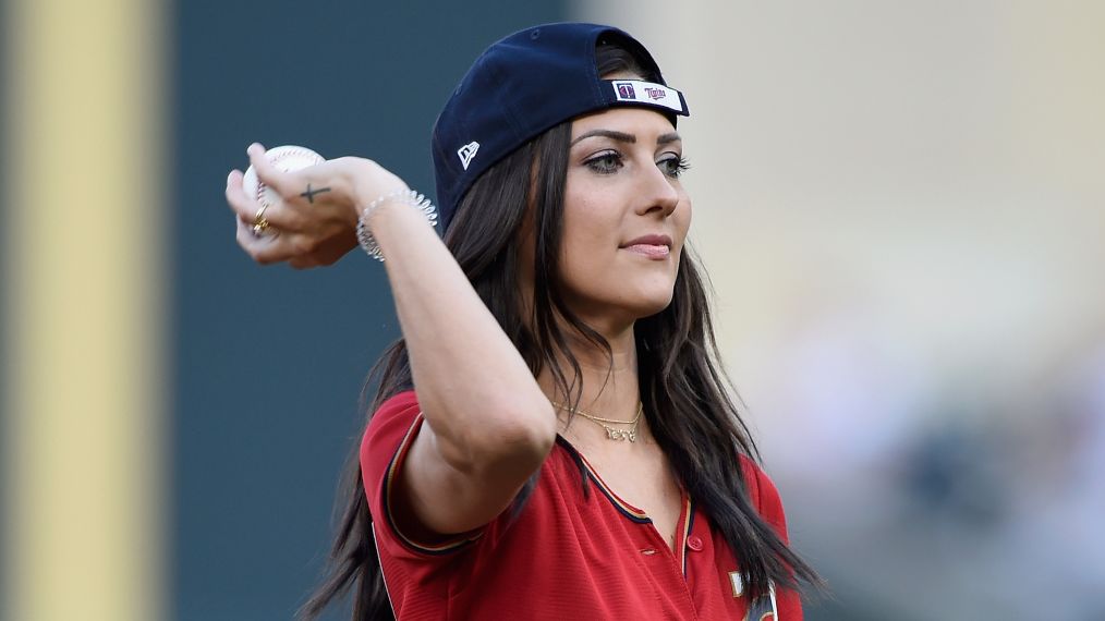 Becca Kufrin throws a pitch at the Kansas City Royals v Minnesota Twins game