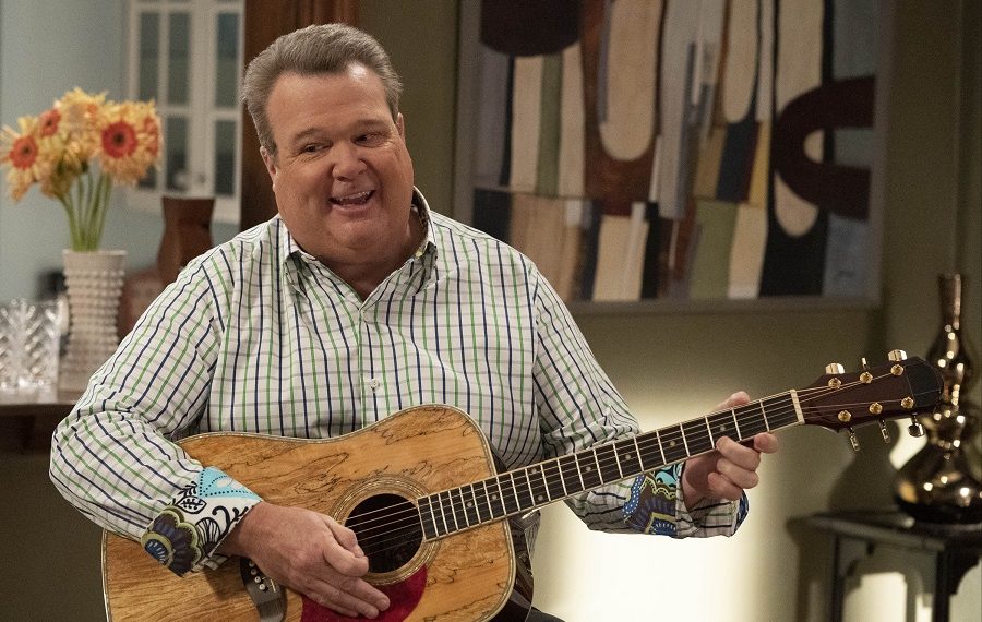 Eric Stonestreet playing guitar in Modern Family