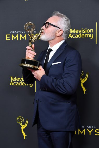 Bradley Whitford kisses his Emmy for Outstanding Guest Actor in a Drama Series Award for 'The Handmaid's Tale'