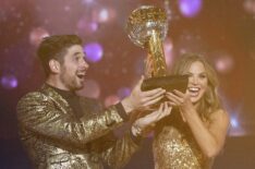 Alan Bersten and Hannah Brown hold up the trophy on Dancing With The Stars