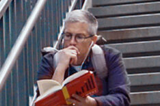 Abby McEnany reading on the steps in Work in Progress