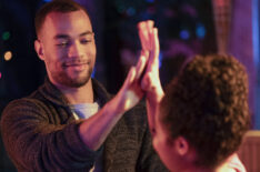 Kendrick Sampson high-fiving Aisha Dee in Ghosting: The Spirit of Christmas