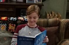 Ames McNamara as Mark reading a book in The Conners