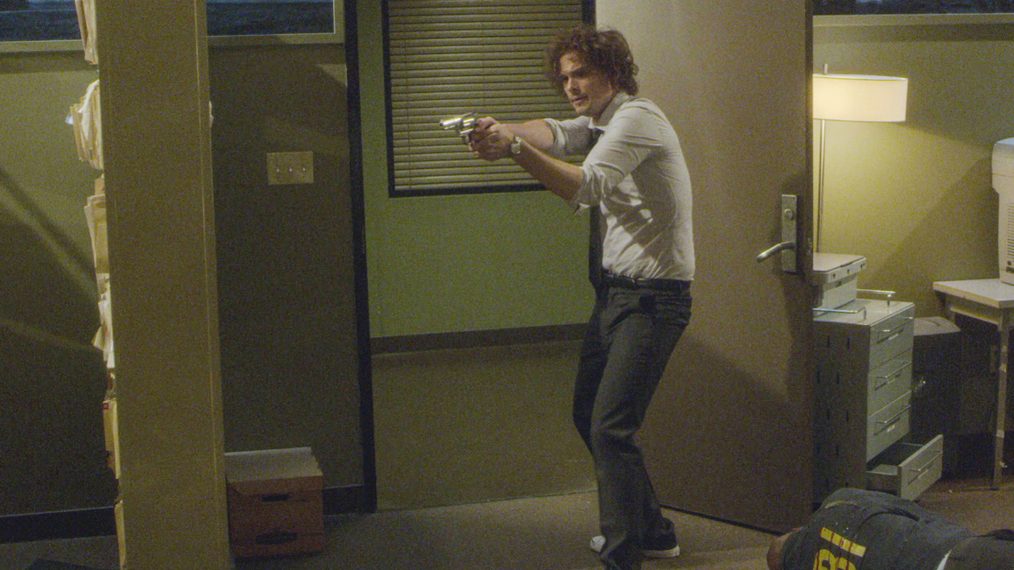 Matthew Gray Gubler as Dr. Spencer Reid holding a gun in Criminal Minds