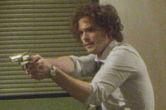 Matthew Gray Gubler as Dr. Spencer Reid holding a gun in Criminal Minds