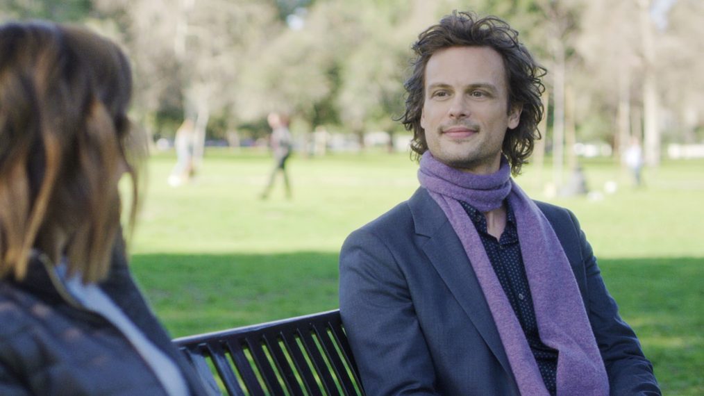 Matthew Gray Gubler on Criminal Minds sitting on a bench with purple scarf