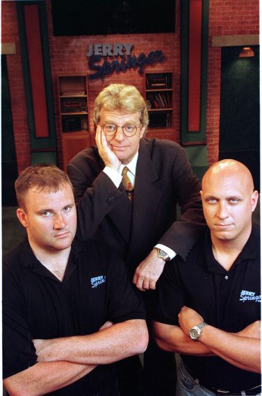 TV talk show host Jerry Springer poses with two of his bodyguards on the set of The Jerry Springer Show