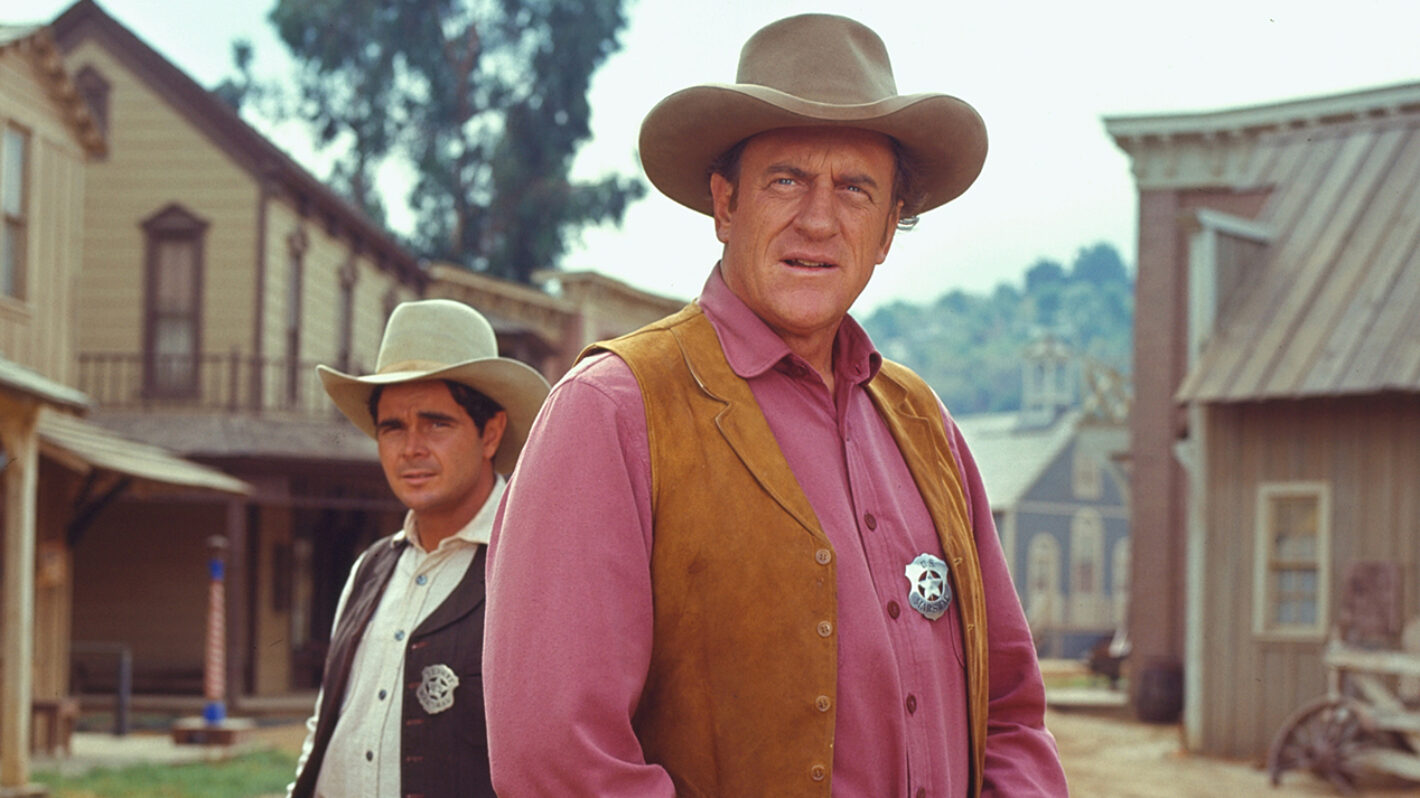 James Arness (as U.S. Marshal Matt Dillon) and Buck Taylor (as Newly O'Brien) from the television series 'Gunsmoke'