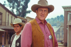 James Arness (as U.S. Marshal Matt Dillon) and Buck Taylor (as Newly O'Brien) from the television series 'Gunsmoke'