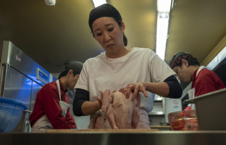 Sandra Oh preparing a chicken in Killing Eve