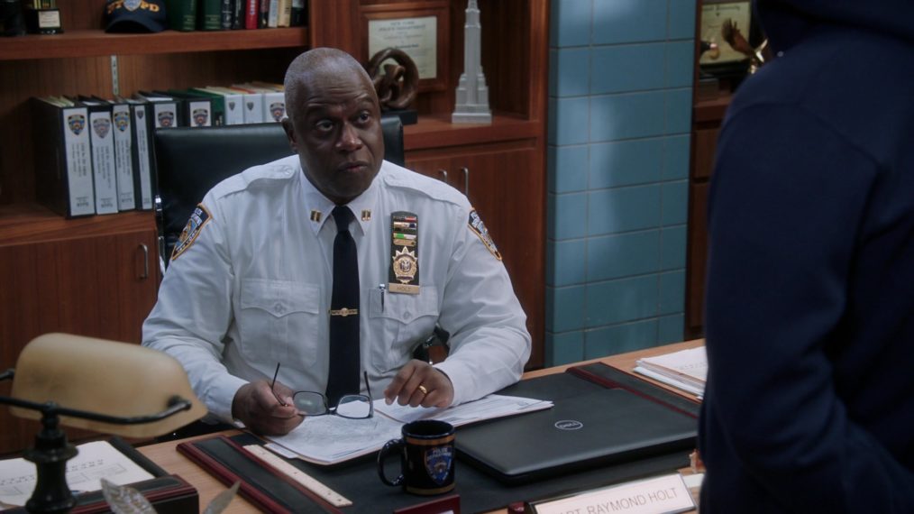 Captain Holt (Andre Braugher) looks up from his very important looking work