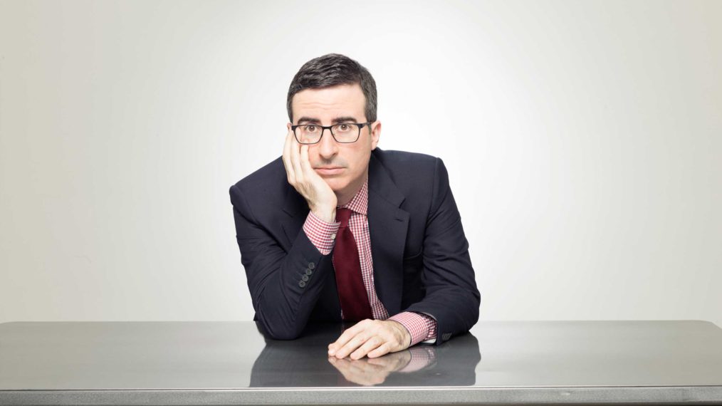 John Oliver behind blank white background in promotional image