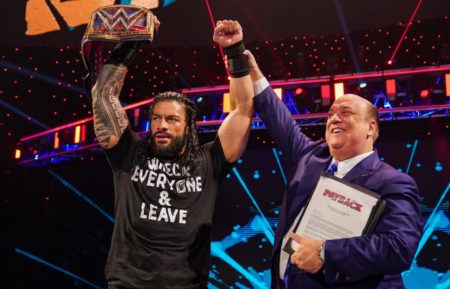 Paul Heyman celebrating with Roman Reigns