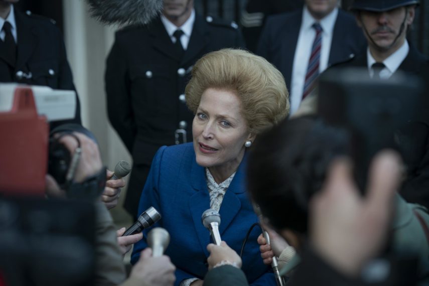 Margaret Thatcher (Gillian Anderson) takes questions from reporters