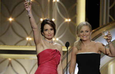 Tina Fey and Amy Poehler speak onstage during the 71st Annual Golden Globe Award