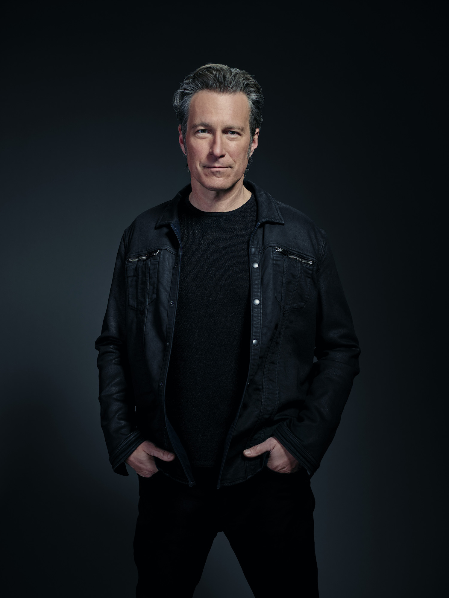 John Corbett as Grady Bello in Rebel